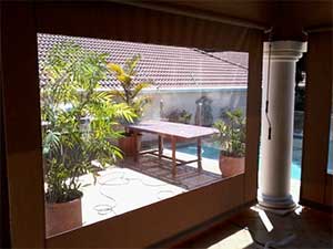 Gear operated roller blind with clear PVC window inside